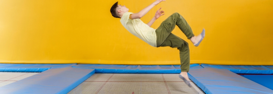 Man on a trampoline about to land on his back