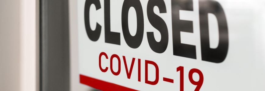 Storefront sign indicating closed due to COVID-19