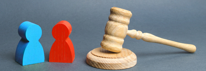 Two figures of people opponents stand near the judge's gavel.