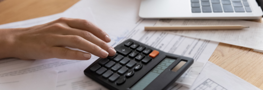 Close up cropped view of young woman enterpreneur hands doing financial paperwork check money savings sum on bank account calculating goods service price paying bills