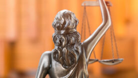 Lady justice with a blurred orange background