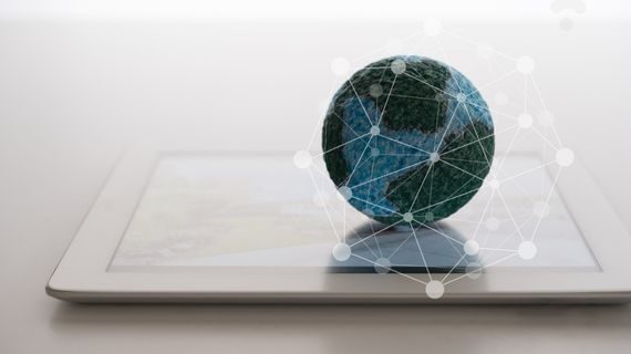 Globe concept atop a tablet on a tabletop