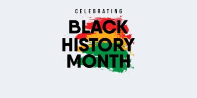 Graphic with words "Celebrating Black History Month" with red yellow and green colours splashed on the background