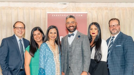 Colleagues posing for a photo at an evening event