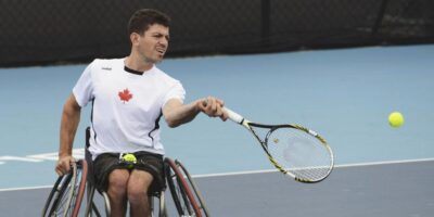 Joel Dembe playing tennis from a wheelchair