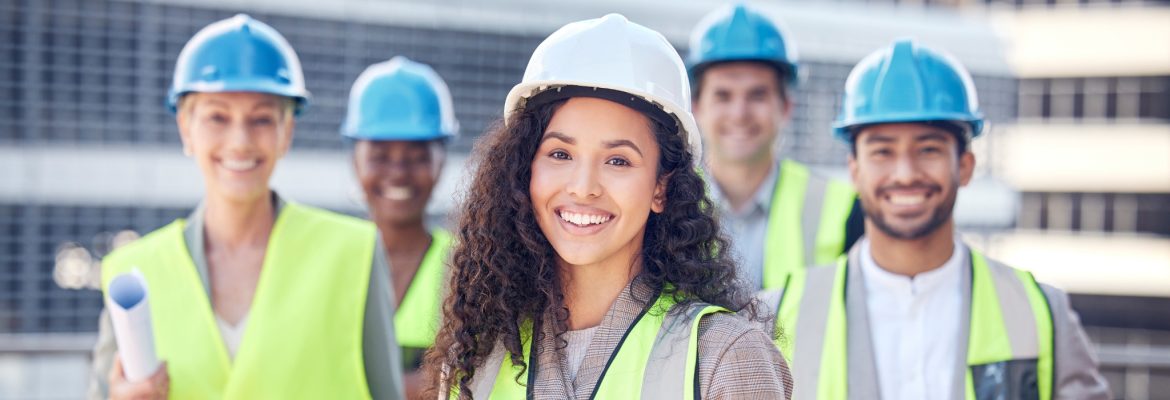 On site, on demand. Cropped shot of a female construction worker standing outside on a building site with her colleagues.