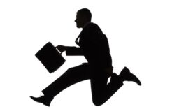 Silhouette of jumping businessman with briefcase