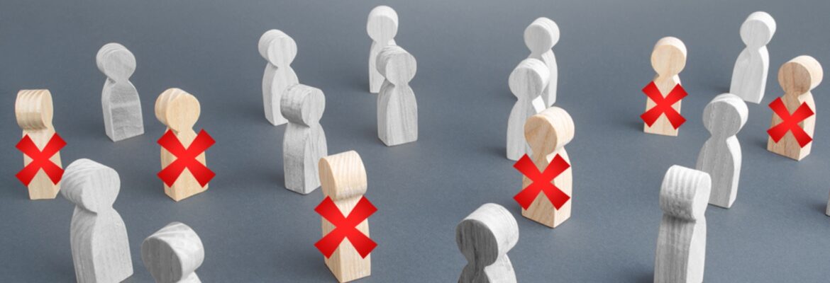 A group of wooden figurines representing people, some of them are crossed out with a red cross.