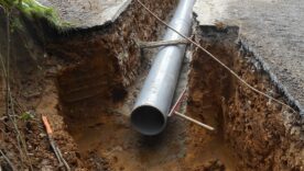 Drain being installed in a dug trench