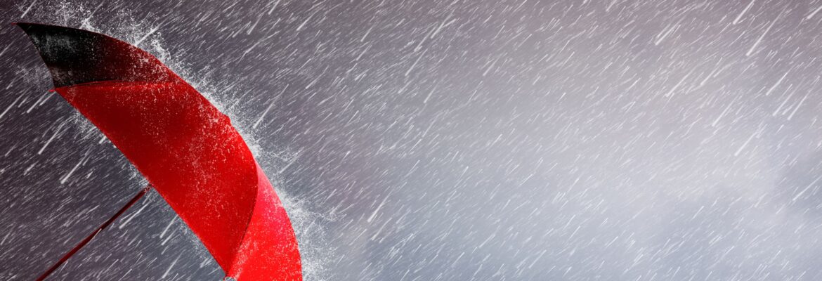 Red umbrella against a stormy background