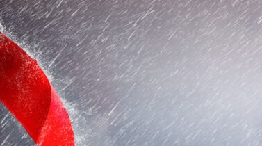 Red umbrella against a stormy background