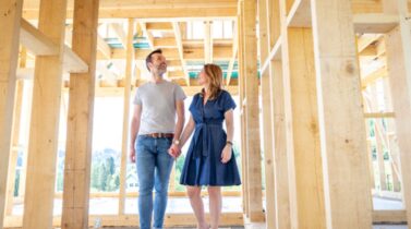 Couple visiting house under construction.