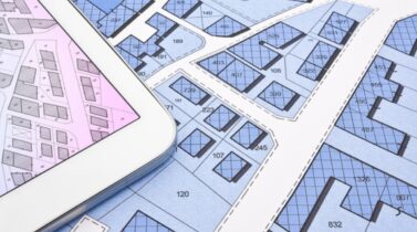 Buildings Permit concept with imaginary cadastral on digital tablet - building activity and construction industry with General Urban Plan.