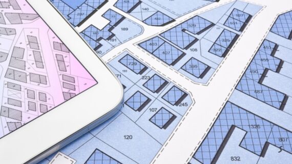 Buildings Permit concept with imaginary cadastral on digital tablet - building activity and construction industry with General Urban Plan.